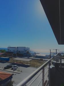 a view of the beach from a balcony of a building at Aleksandra Delfini Apartments in Paralia Katerinis