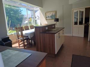 a living room with a table and a dining room at Ethan House in Killarney