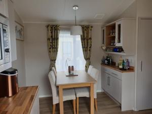 a kitchen with a table and chairs in a kitchen at K7 Annandale in Winthorpe +6 photos