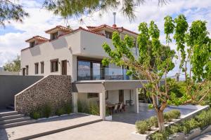 a villa with a view of the house at Villa Rock&SeaView in Livanates