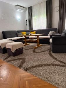 a living room with couches and a table on a rug at Cerak lux in Bele Vode +19 photos