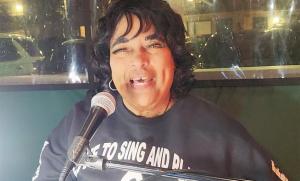 a man is talking into a microphone at Arbors at Island Landing Hotel & Suites in Pigeon Forge