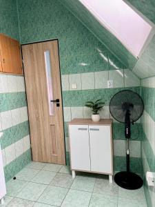 a room with a room with a fan and a door at Dom Gościnny Tomasz Mielenko in Mielenko +15 photos