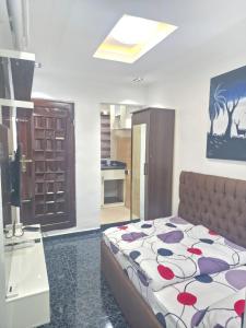 a bedroom with a bed and a kitchen at The Pointe Apartments in Agege +5 photos
