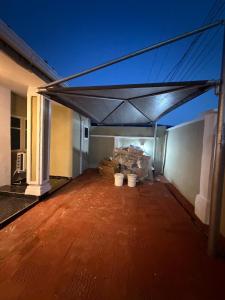 a patio with awning and buckets on top of a building at The Pointe Apartments in Agege