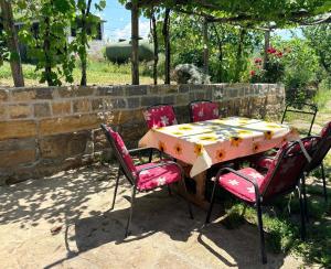 a table with four chairs and a table with at Apartma Zari in Marezige