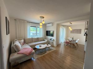 a living room with a couch and a table at Apartman I&I in Kiseljak