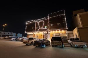 a parking lot with cars parked in front of a building at راحتي هنا للشقق المخدومة 7 in Riyadh