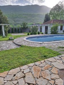 a backyard with a swimming pool and a house at Small house in Danilovgrad