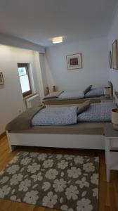 two beds sitting in a room with a rug at Casa di Traditionale im Herzen von Bad Aibling Tradition trifft auf moderne Gemütlichkeit auf 138qm in Bad Aibling