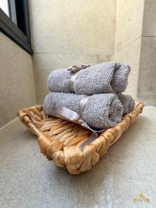 a pile of towels in a basket on the floor at Urban Waves 1 in Netanya +8 photos