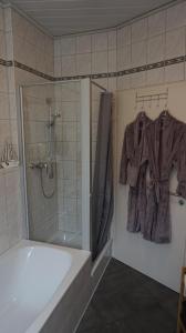a bathroom with a shower and a robe on a rack at Casa di Traditionale im Herzen von Bad Aibling Tradition trifft auf moderne Gemütlichkeit auf 138qm in Bad Aibling +59 photos