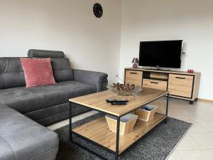 a living room with a couch and a coffee table at Ferienwohnung Tor zum Oberwald in Herbstein