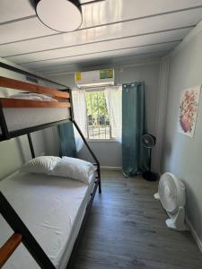 a room with two bunk beds and a window at Family Wolf - El Chorro in Paquera