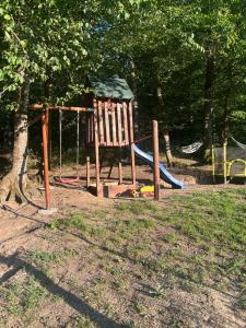 a playground with a swing set in a park at Cabana Icas in Dej