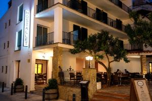 a hotel with a restaurant in front of a building at L´Hostalet in Tossa de Mar +10 photos