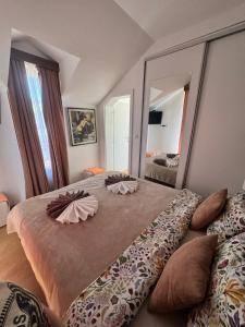 a bedroom with a large bed with a large mirror at Crown TiM Villa in Vrnjačka Banja +32 photos