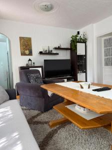 a living room with a couch and a table at Cerak lux in Bele Vode