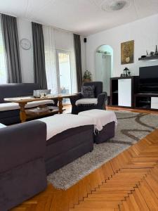 a living room with a couch and a table at Cerak lux in Bele Vode