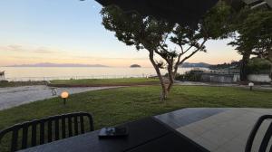 a patio with a table and a view of the water at The House On The Beach in Paleo Tsifliki