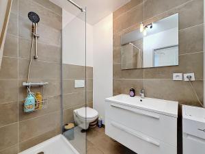 a bathroom with a shower and a toilet and a sink at L'Arrière Cour in Montbéliard