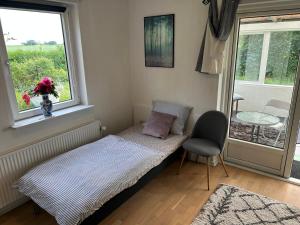 a small room with a bed and a window at FLC 11 Rooms in Rødby