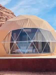a large tent with glass windows in the desert at Tala Camp in Disah