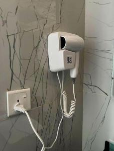 a phone with a cord plugged into a wall at Tala Camp in Disah