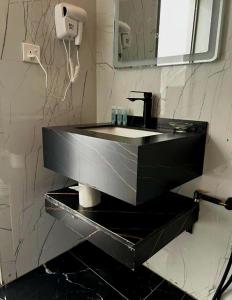 a bathroom with a black sink and a mirror at Tala Camp in Disah +91 photos