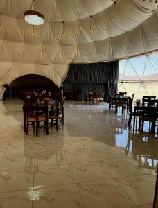 a dining room with tables and chairs in a tent at Tala Camp in Disah