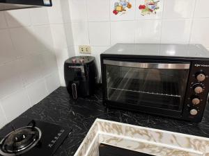 a microwave sitting on a counter in a kitchen at Affordable pool villa in premium location in Pattaya +5 photos