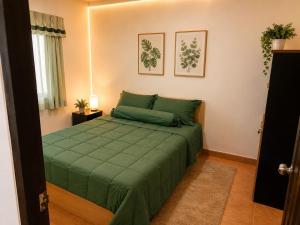 a bedroom with a green bed in a room at Affordable pool villa in premium location in Pattaya