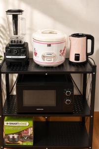 a black shelf with a blender and a toaster at Affordable pool villa in premium location in Pattaya