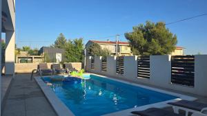 a swimming pool in a backyard with a fence at Villa Rosa - Luxury Apartments in Vrsi
