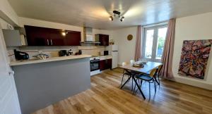 a kitchen with a table and a counter top at L'appart de saint léo in Saint-Léonard-de-Noblat