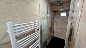 a bathroom with a shower and a glass door at L'appart de saint léo in Saint-Léonard-de-Noblat +10 photos
