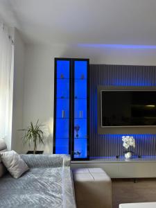 a bedroom with blue drawers and a television at Mme apartment in Kamëz +4 photos
