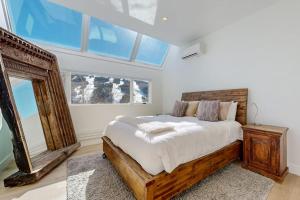 a bedroom with a large bed and a window at Snowfall Sanctuary, Unit 12 in Vail