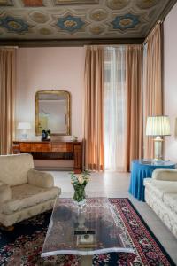 a living room with a couch and a table at Hotel Roma in Bologna +229 photos