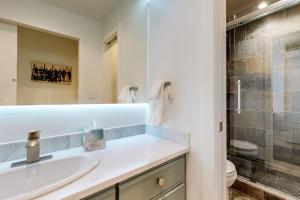 a bathroom with a sink and a toilet at Snowfall Sanctuary, Unit 12 in Vail +53 photos