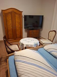 a living room with two beds and a flat screen tv at Haus Rieder in Wörgl