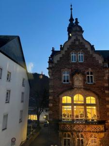 a large brick building with a clock on it at Vis-a-vis Apartments in Traben-Trarbach