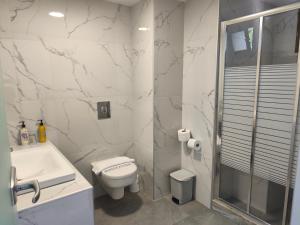 a bathroom with a toilet and a shower and a sink at Aegean Blue Studios in Afitos +106 photos