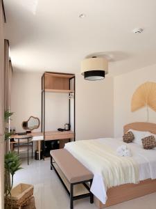 a bedroom with a large bed and a desk at Olivea Boutique Hotel Phu Quoc in Phú Quốc +75 photos