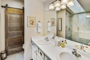 a bathroom with two sinks and a shower at Aspen Getaway in Edwards +33 photos