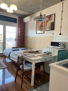 a kitchen with a bed and a table in a room at Lux Lotnisko in Wrocław