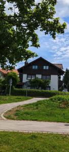 a house with a road in front of it at Apartment mit Seeblick - Hopfen am See in Füssen