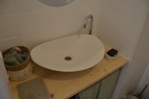 a bathroom with a white sink on a wooden counter at Am Burg in Klotten +3 photos