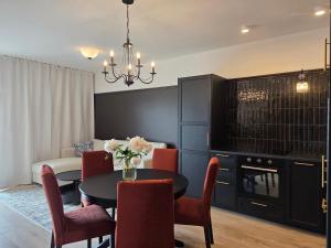 a living room with a dining room table and chairs at Apartamenty Stargardt in Stargard
