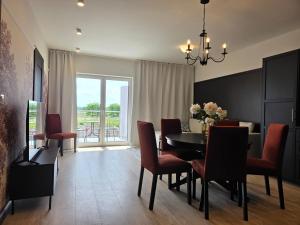 a dining room with a table and chairs and a window at Apartamenty Stargardt in Stargard +9 photos
